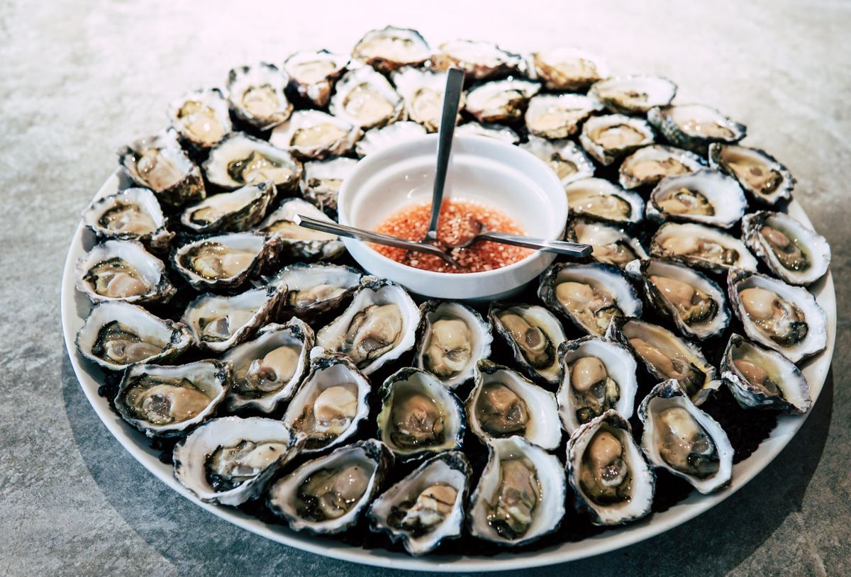 A platter of fresh oysters with dipping sauce, the kind served at the Oyster Bash